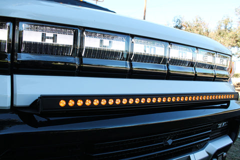 white 2023 hummer ev with amber backglow 40in light bar in the front