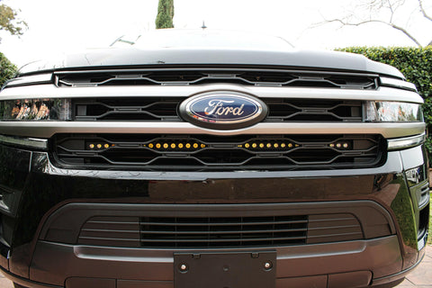 front view of black ford expedition with behind grille led light bar for off roading