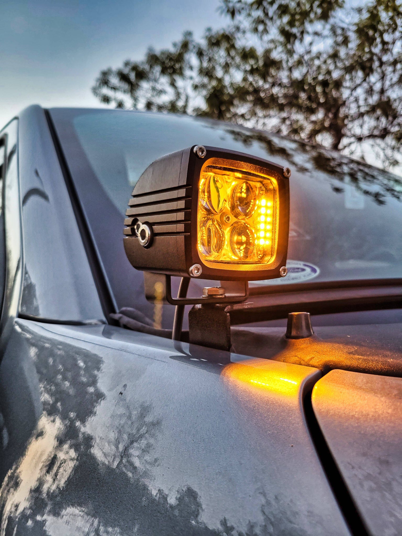 up close view of a 3.25in ditch light pod on a ford f150 with amber backlights