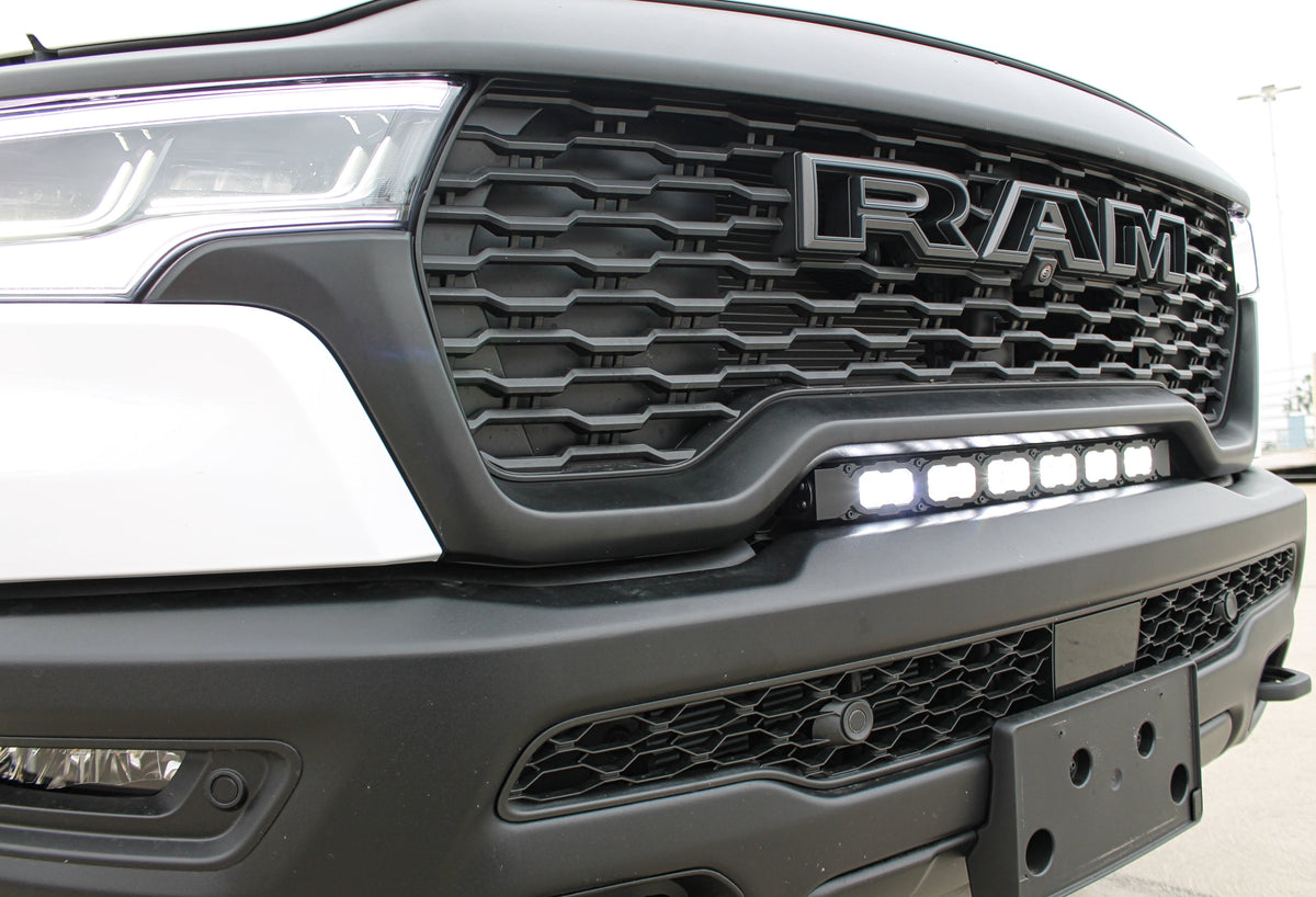 2025 RAM 1500 RHO with the M&R 23in PRO curved LED light bar installed between the grille and bumper