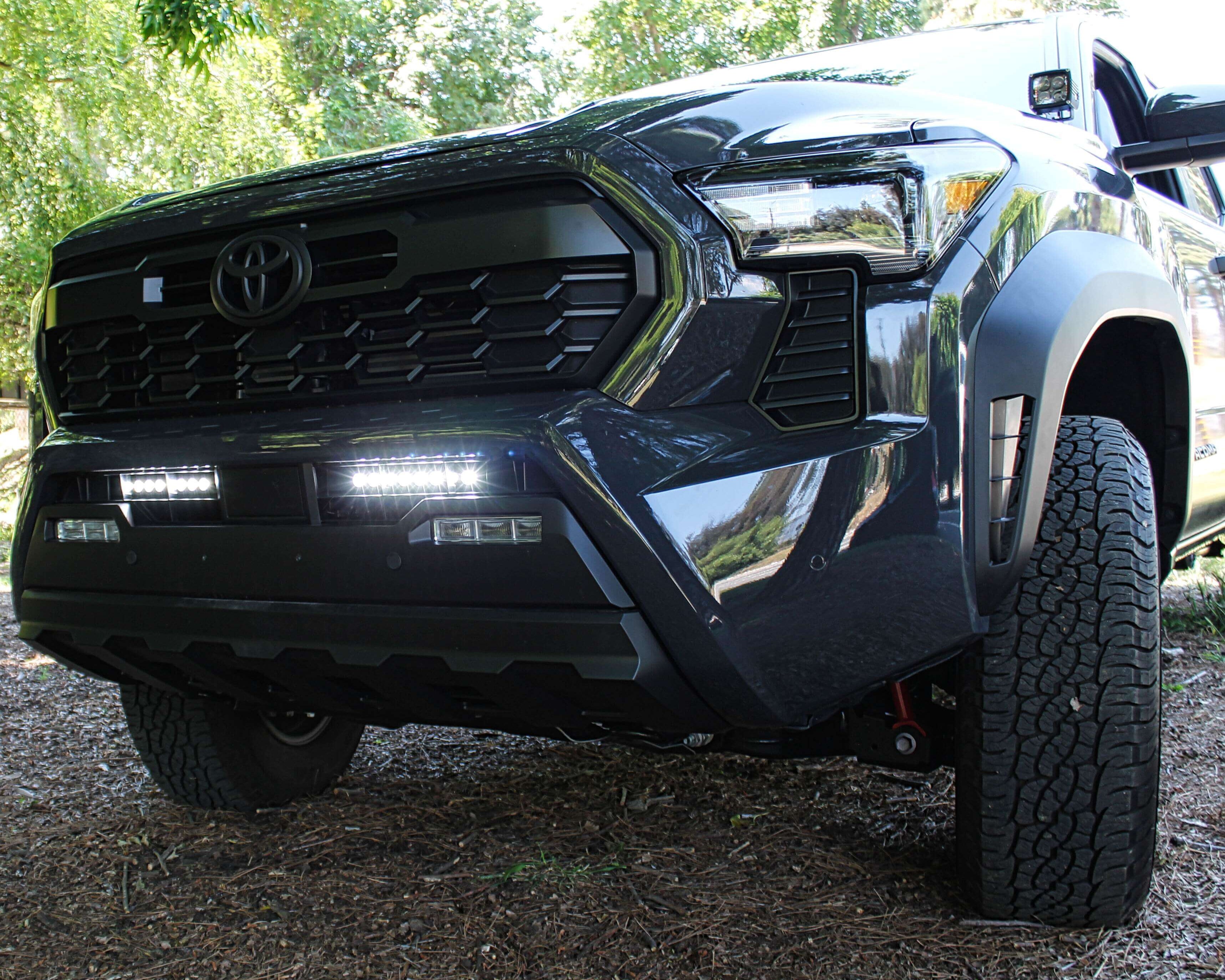 2024 Toyota Tacoma front view in rugged off-road setting