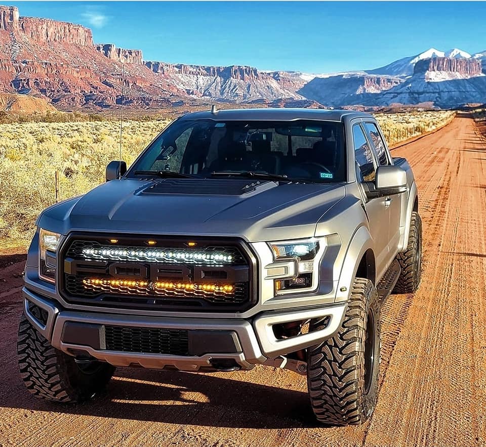 Ford Raptor Gen 2 Lights off-road LED lighting on silver 2017-2020 Raptor driving desert dirt road at sunset