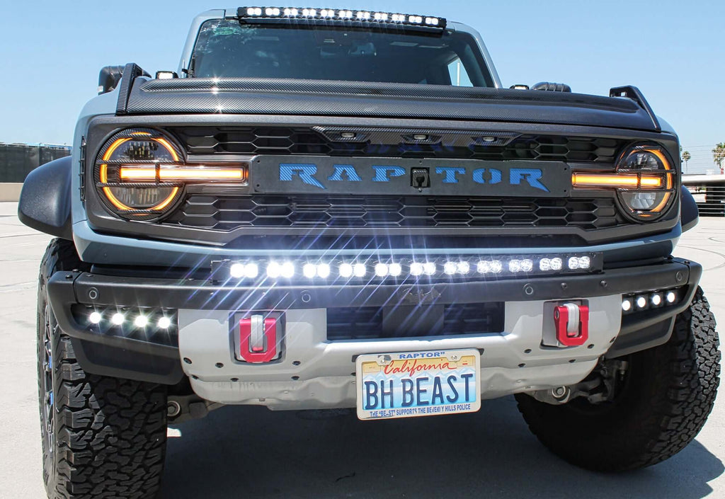 2022 2023 2024 red Ford Bronco Raptor with white 40in light bar on top of bumper and dual function fog light kits by M&R automotive