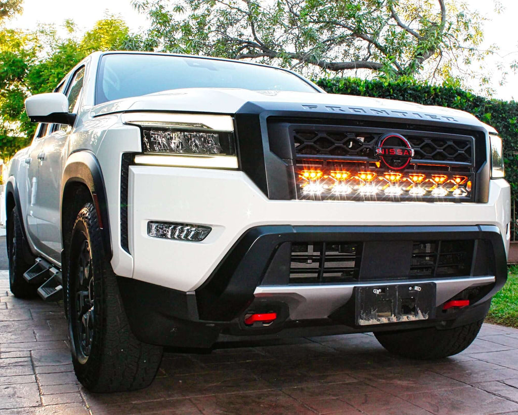 2022 2023 2024 white Nissan Frontier with two 30in light bars color white and amber behind the grille by M&R automotive