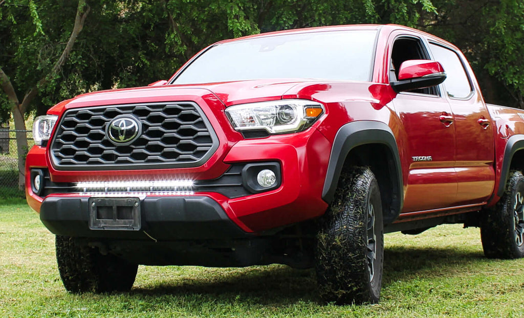 2016-2023 red Toyota Tacoma with one white 40in light bar under the grille for off roading by M&R automotive 