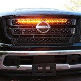 black nissan titan with one led light bar behind the grille in amber color for off roading