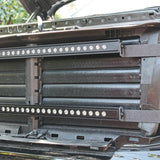 nissan titan grille off showing two led light bars and metal brackets for off roading