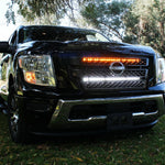 black nissan titan with off road led light bars behind the grille