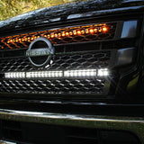 black nissan titan with off road led light bars behind the grille white and amber  up close view
