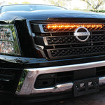 black nissan titan with one amber light bar behind the grille for off roading