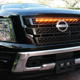 black nissan titan with one amber light bar behind the grille for off roading
