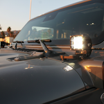 Jeep Wrangler ditch lights on JL model with dual-function LED pods for 2017-2024, mounting on hood near windshield