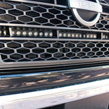 up close view of grille on nissan titan with one led light bar behind the grille in for off roading below the nissan logo