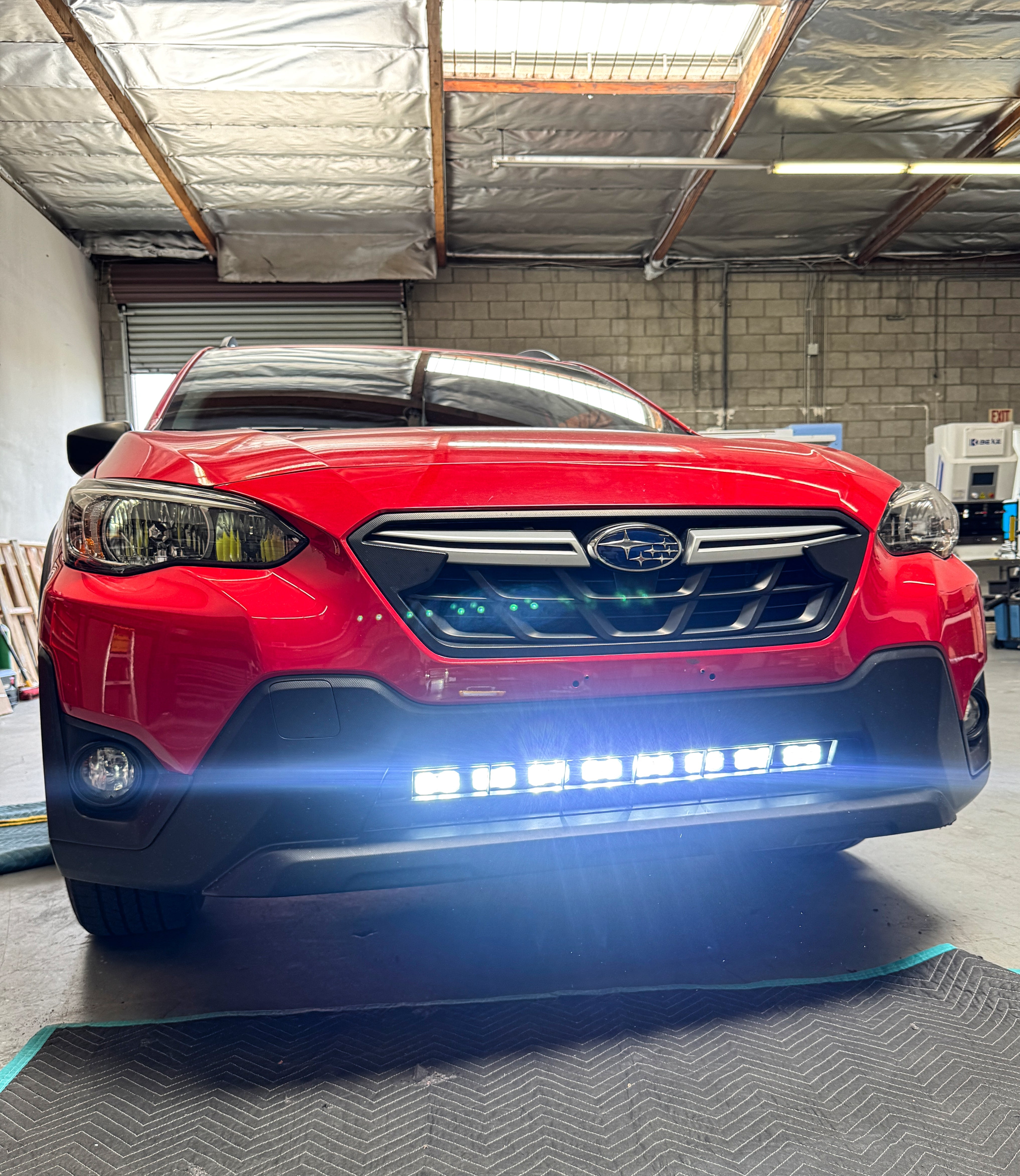 red 2023 subaru crosstrek gen 2 light bar off roading in lower grille