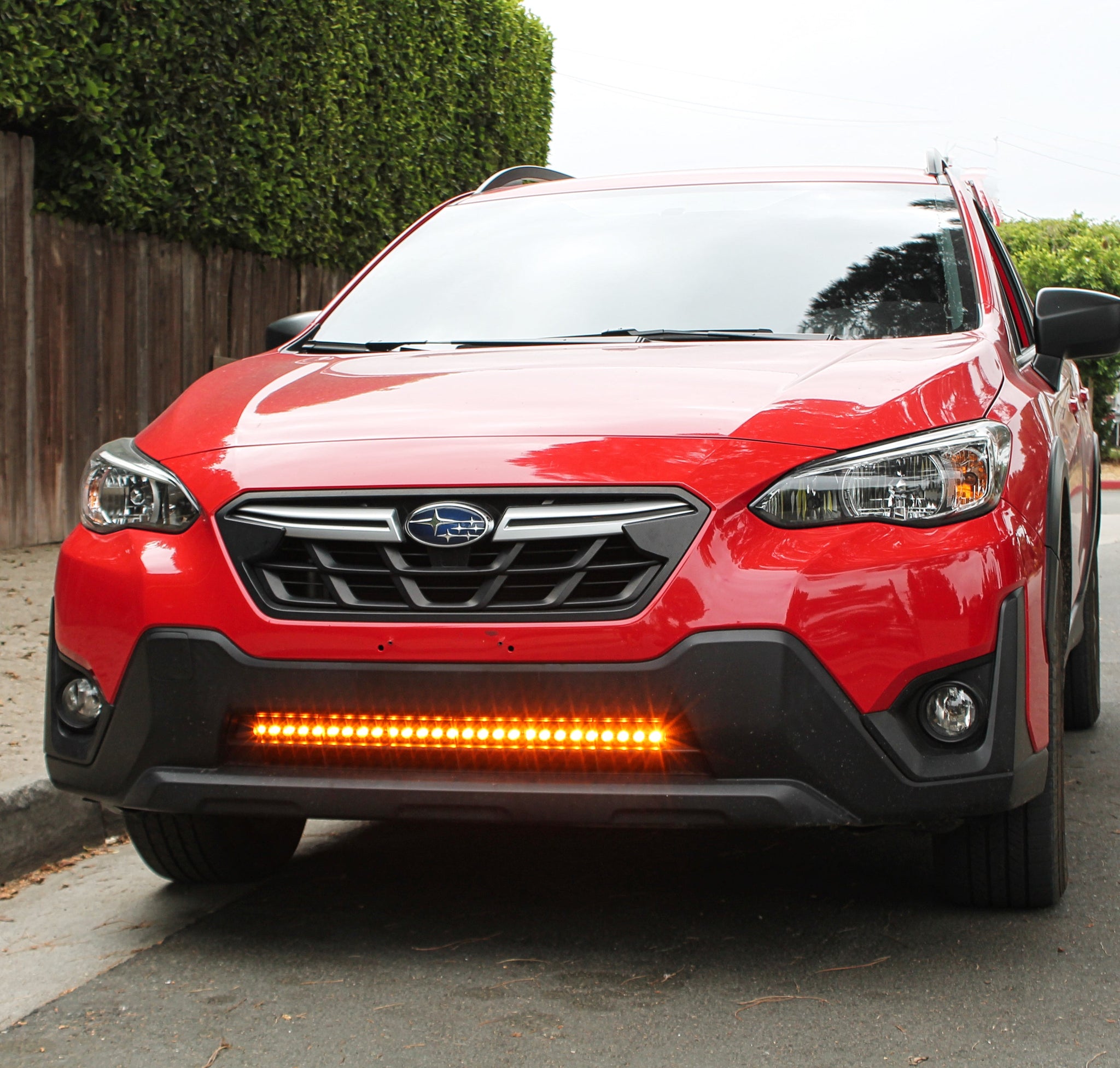 red 2021 subaru crosstrek gen 2 with light bar in lower grille for off roading