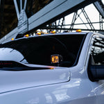 Alt Tag: 2025+ RAM 2500 3500 Ditch Lights with dual color amber DRL glowing on white heavy duty truck under bridge
