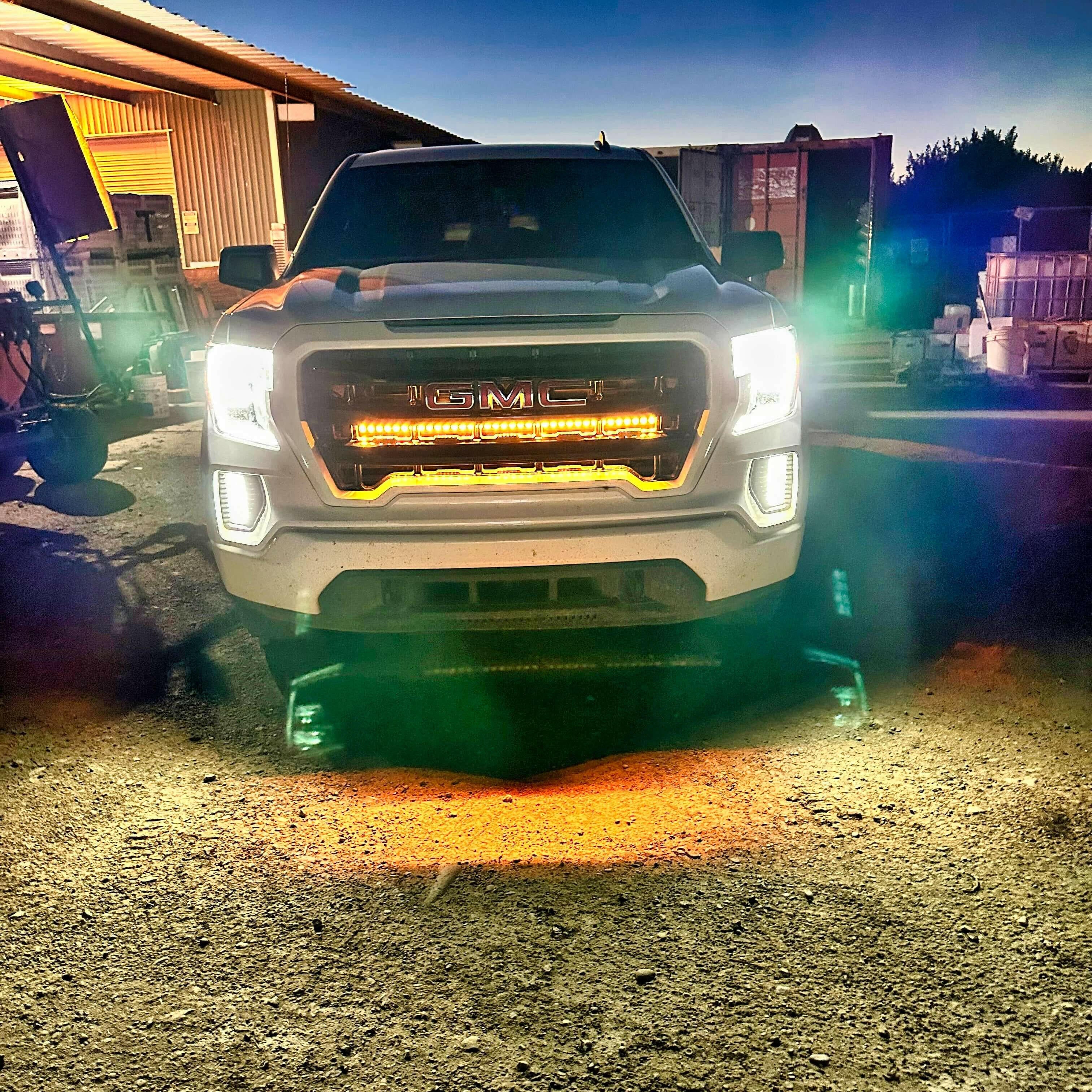 2019 2020 2021 2022 2023 white GMC Sierra 1500 with two amber 40in behind grille light bars