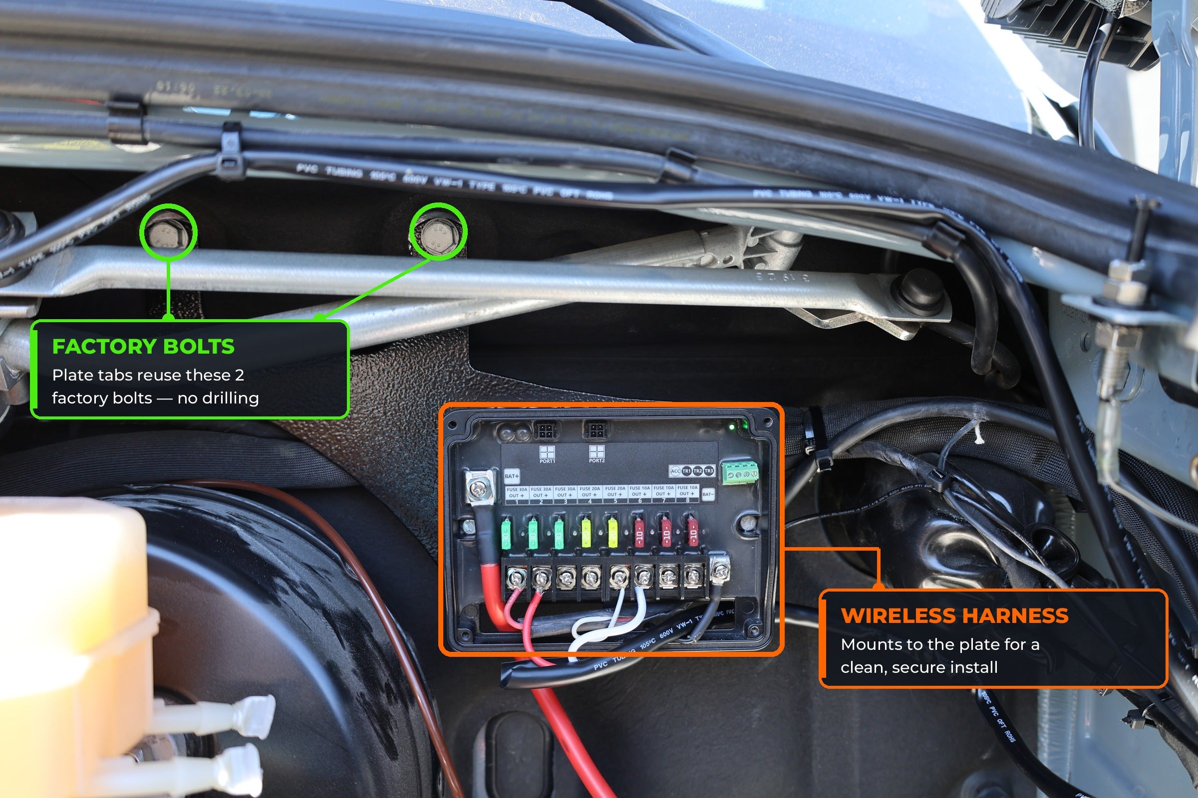 Wireless Harness 2.0 mounting plate installed in a 2019+ Mercedes Sprinter engine bay, bolted to the 2 factory bolts with the harness fuse box mounted on it