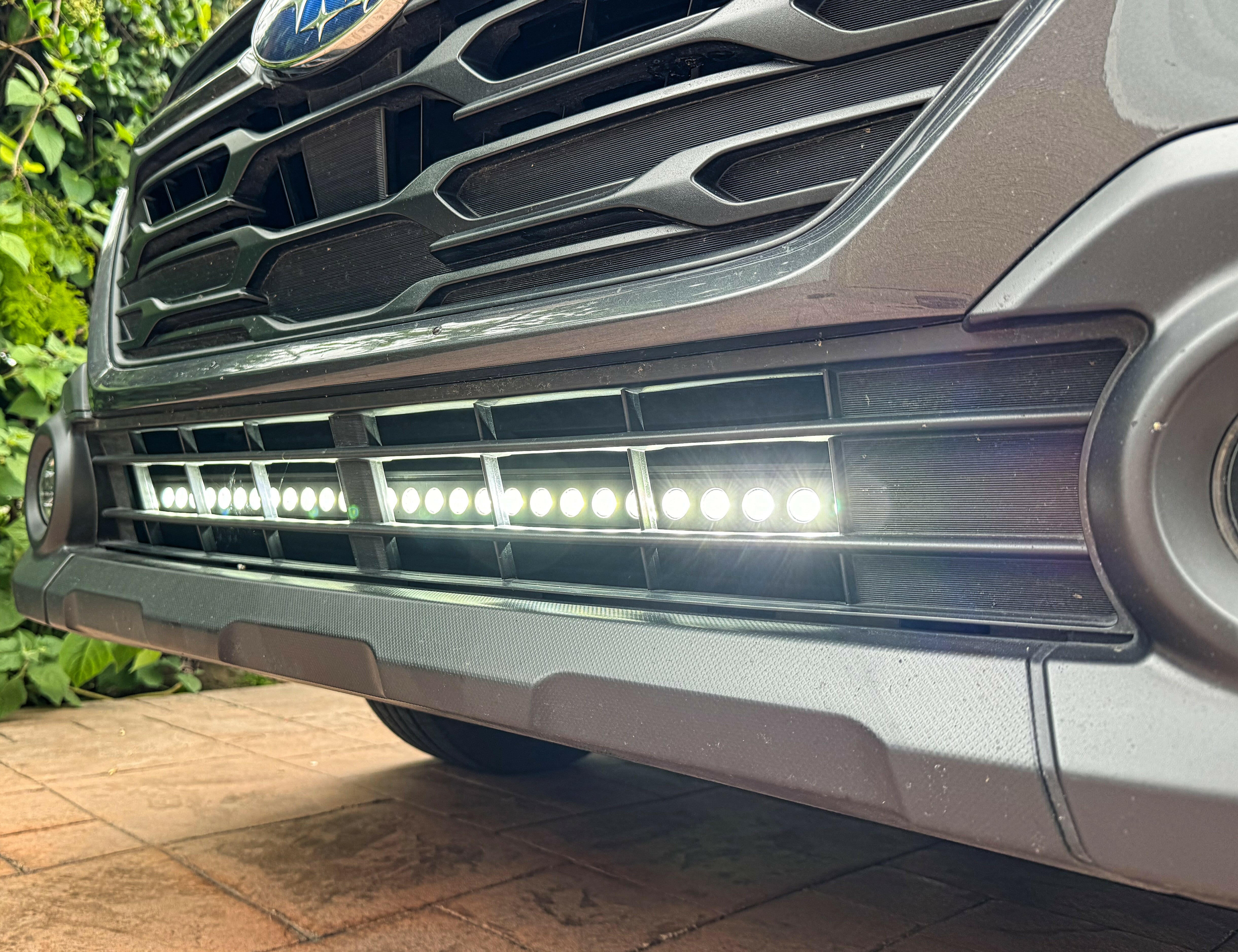 grey subaru outback with led light bar off roading