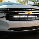white 2021 2022 2023 2024 Chevrolet Suburban with one led white light bars behind the grille for off roading
