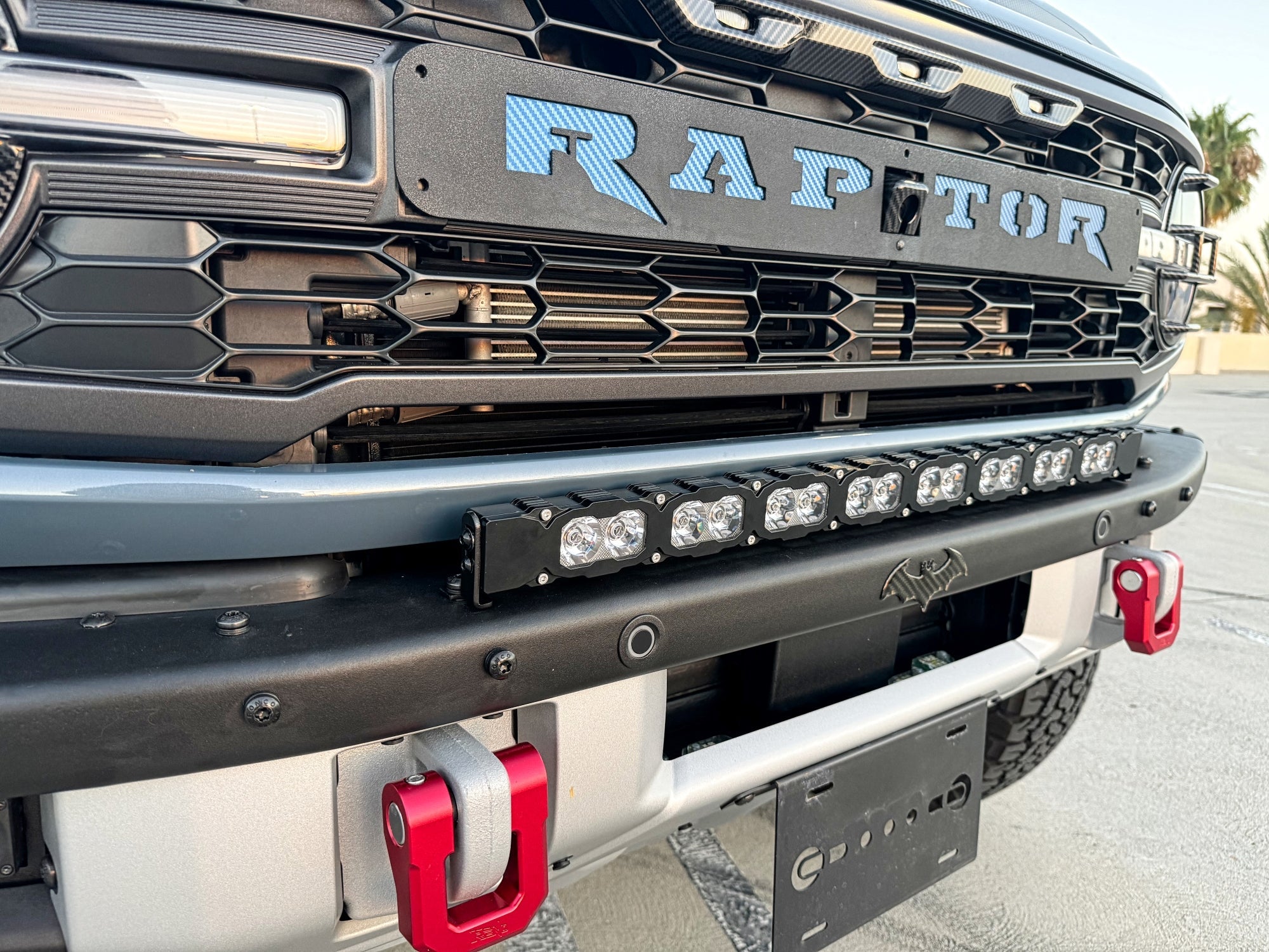 Ford Bronco Raptor 30in Light Bar on front bumper with mounted LED bar, black powder-coated bracket, Raptor badge visible, rugged off-road setup