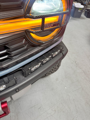 Ford Bronco Raptor Light Bar extension installed on 2021+ with 12in PRO side light bars, fits modular bumper—front view showing header and amber LEDs