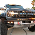 front view ford bronco raptor with amber drl led light bar on bumper and roof plus fog lights
