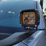 Ditch light LED pod installed on the hood mount bracket of a 2021-2023 Ford F150 next to the windshield