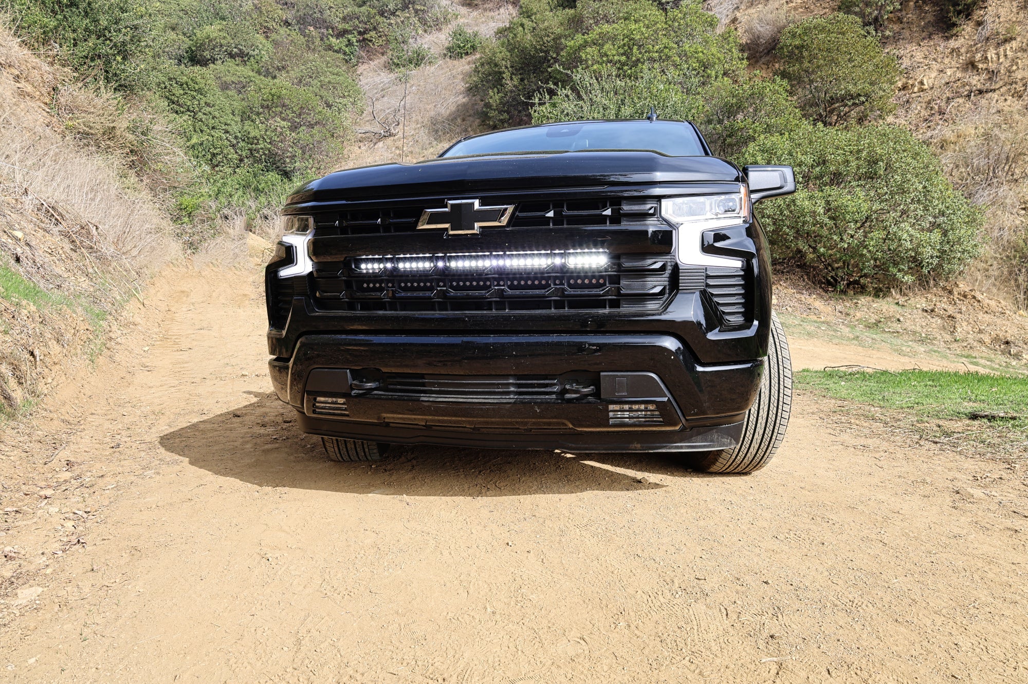 Black 2022+ Chevrolet Silverado 1500 with dual 40in LED light bars behind the front grille