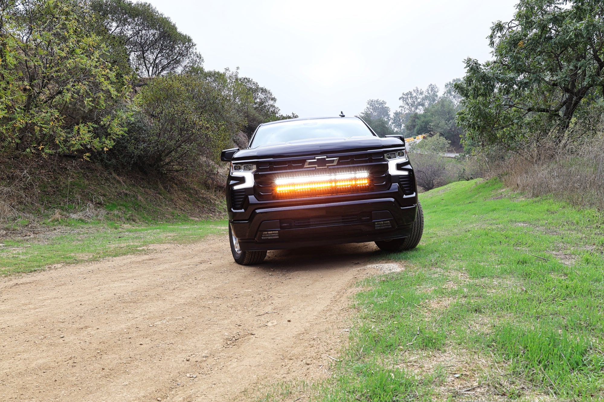 Black Chevrolet Silverado 1500 with dual 40in off-road LED light bars in the grille