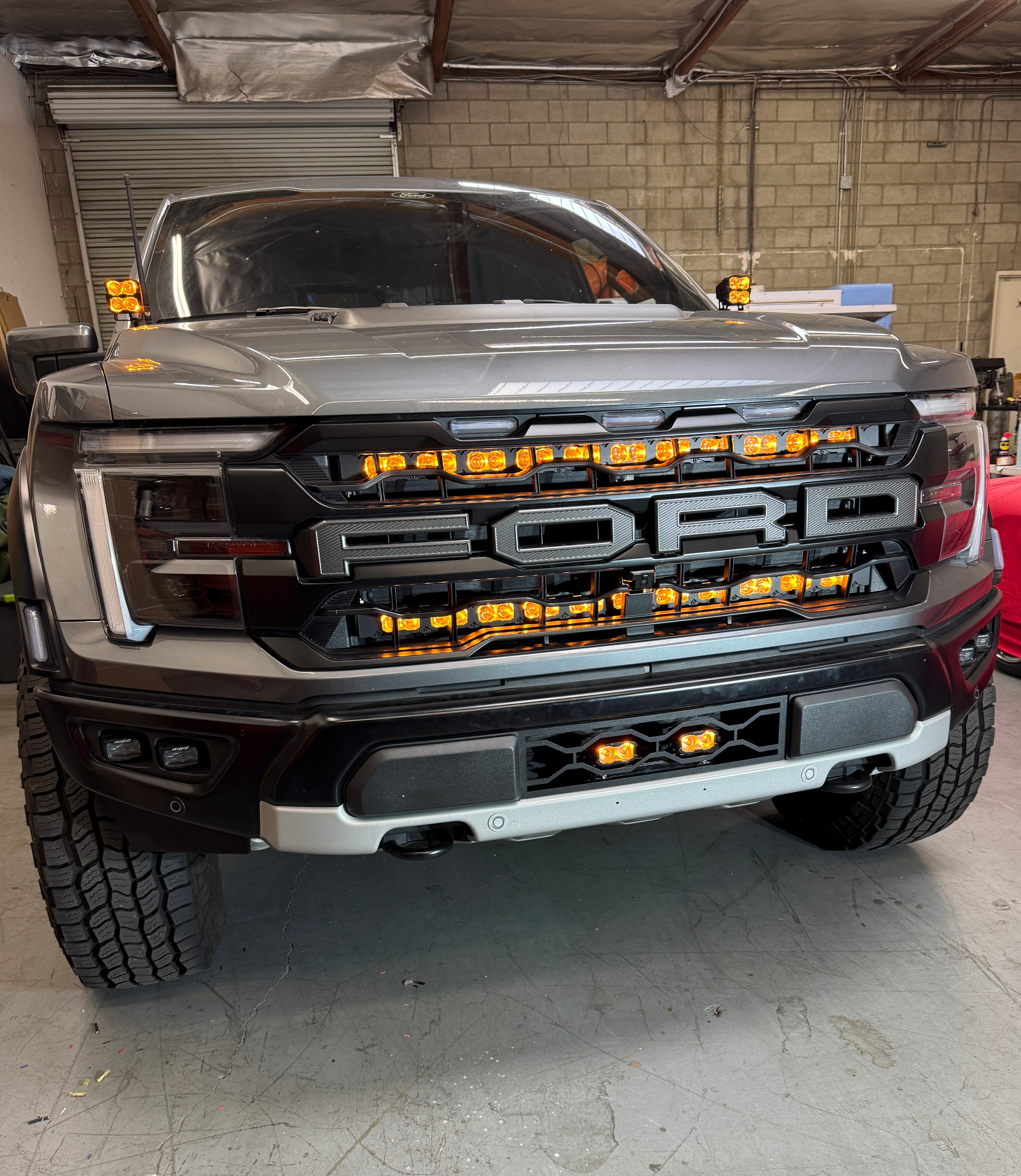 2024+ Ford Raptor Gen 3 Refresh Guard Plate - rugged front view with aggressive front grille and orange LED lights