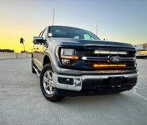 2024-2026 Ford F150 off-road LED light bar kit - dual 30 inch grille-mounted light bars with white LED beam and amber DRL glow, sunset front view