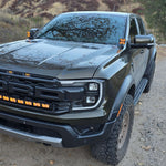 Ranger Raptor ditch lights on 2024+ Ford Ranger Raptor pickup with dual color amber DRL backglow