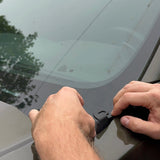 Hands installing hood mount for 2024 Ford Ranger Raptor, demonstrating accessory placement on vehicle.