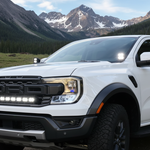 Ranger Raptor ditch lights on a white Ford Ranger Raptor with dual color white and amber DRL backglow during a mountain trip
