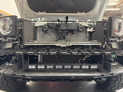 Land Cruiser Light bars on 2024+ Toyota Land Cruiser front with grille removed, showcasing installed light bars and 12 LED pods