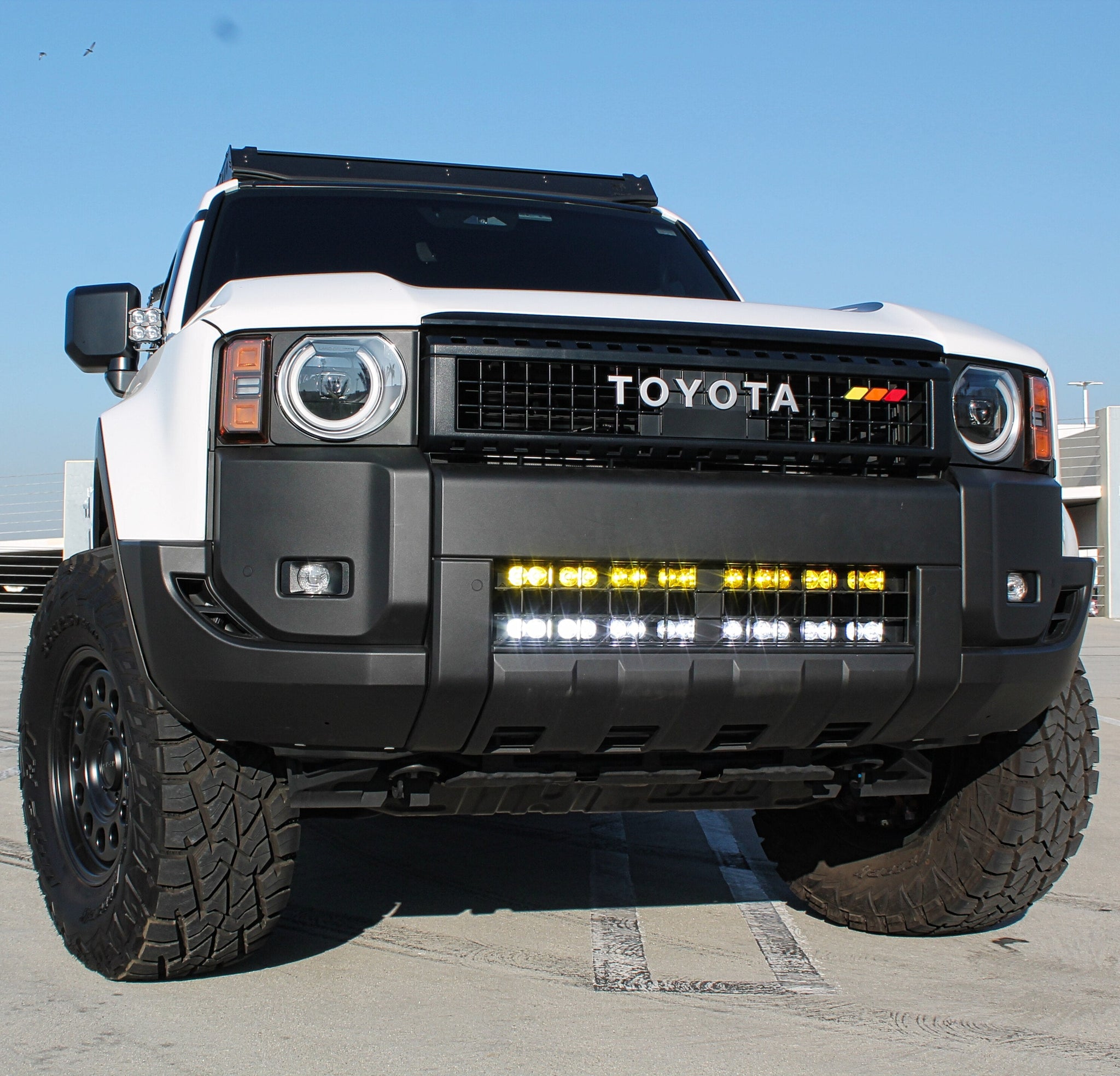 Land Cruiser Light bars on 2024+ Toyota Land Cruiser front view emphasizing off-road LED light bar installed behind bumper grille
