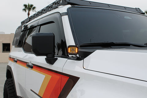 Land Cruiser ditch lights on 2024+ model with amber DRL backglow and white LED main light for Toyota Land Cruiser 2024-2026