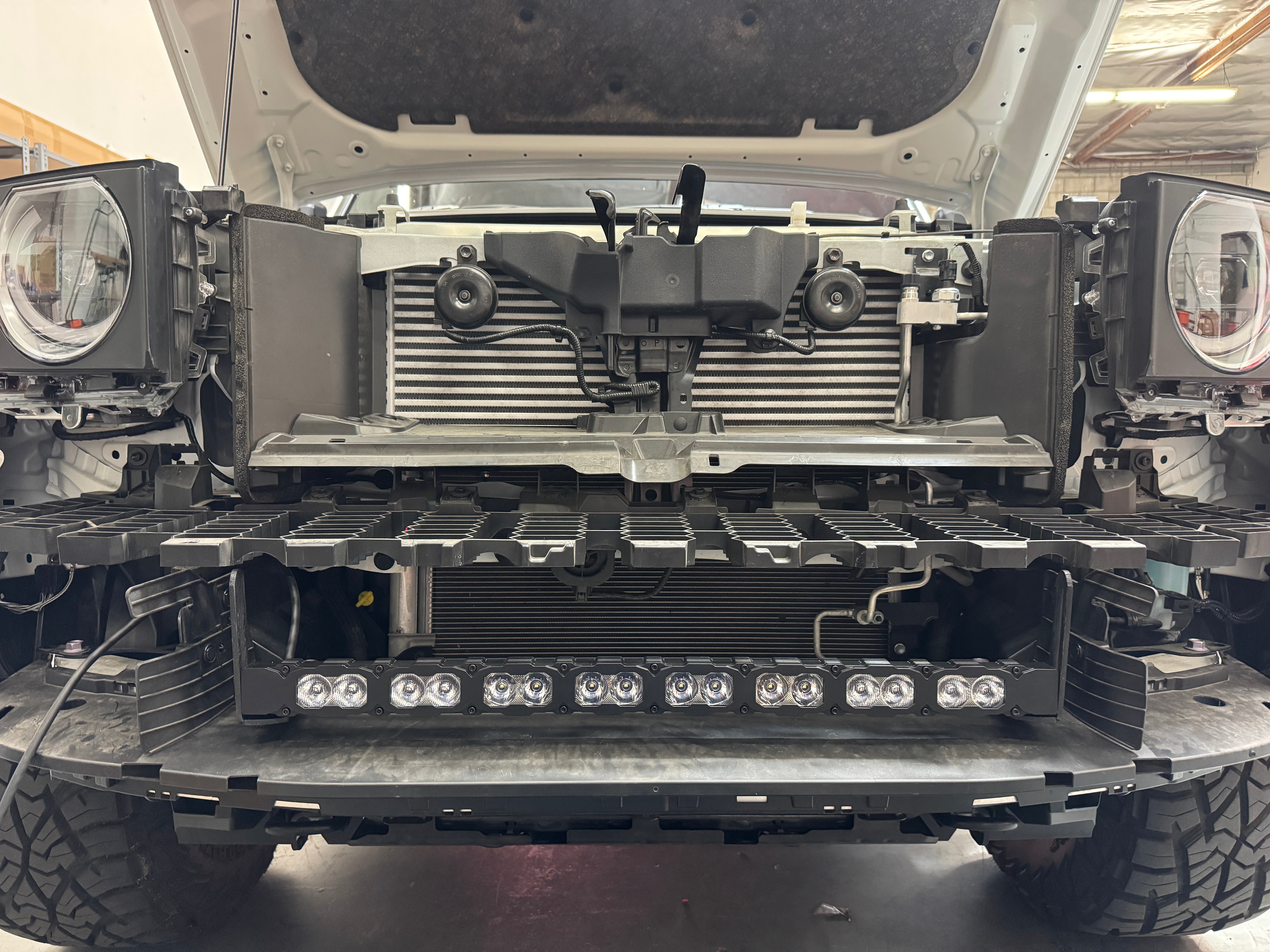 Land Cruiser light bar installed behind the lower grille on 2024+ Toyota Land Cruiser with front grille removed