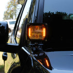 upclose ditch light on new black 2024 toyota tacoma amber light hood mount