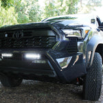 black 2024 toyota tacoma white led iight bars behind grille and ditch lights