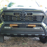 front view gray new toyota tacoma with led light bars behind grille and hood mount kit