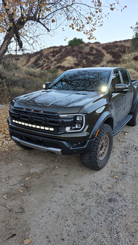 2024 gray ford ranger raptor with white ditch lights and white led light bar for off roading