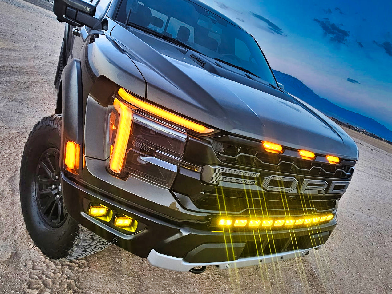 2024+ Ford F150 Raptor with Ford F150 Raptor Light Bar and amber LED lighting on standard bumper.