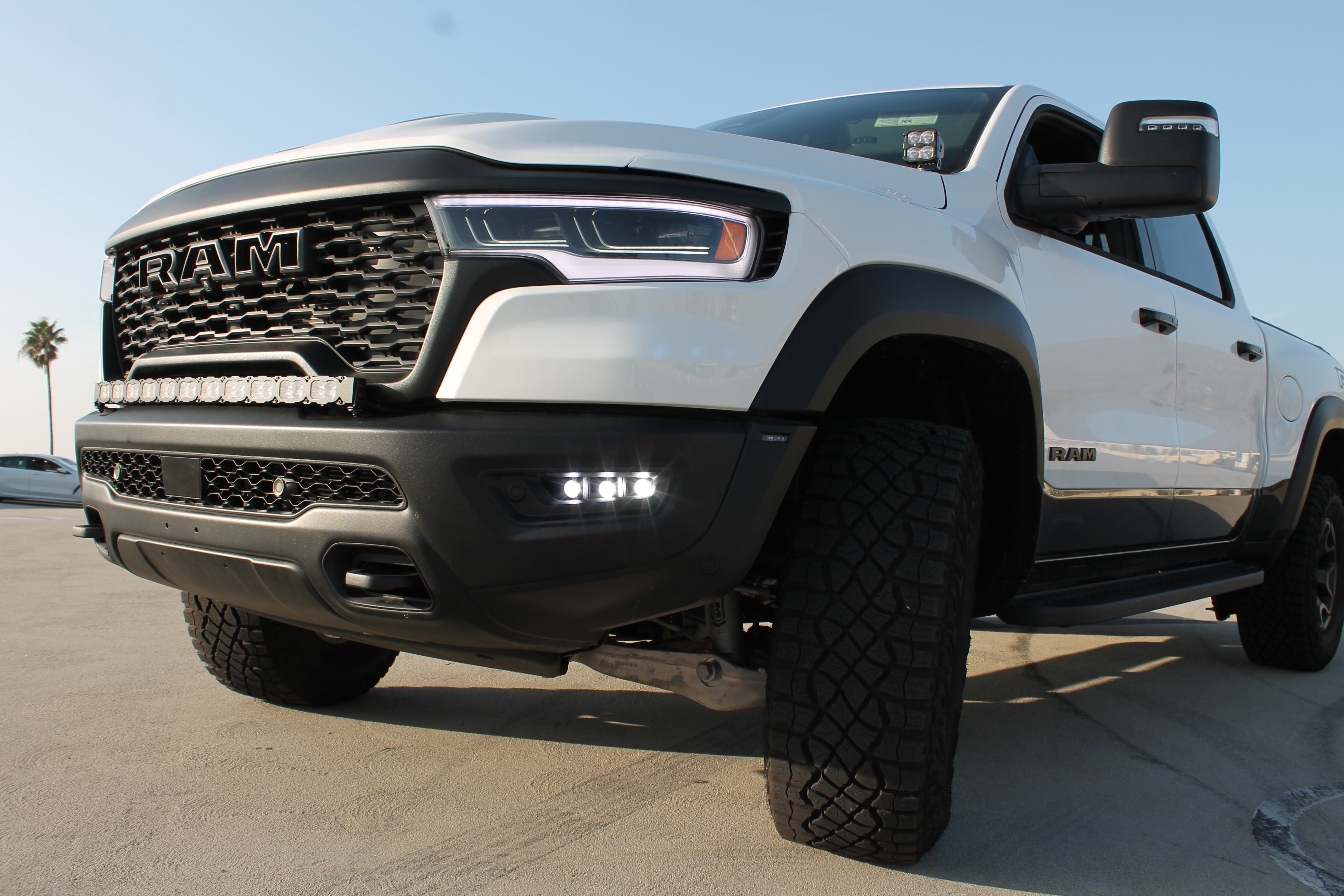 RAM RHO FOG: Bolt-on fog light kit for 2025+ RAM 1500 RHO model with black powder-coated bracket, no cutting, factory openings