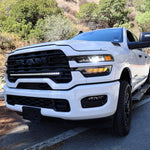 2025+ RAM 2500 light bar 40in slim curved LED installed on white RAM 2500 truck front grille on mountain road