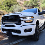 2025+ RAM 2500 light bar 40in slim curved LED installed on white RAM 2500 truck front grille on mountain road