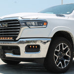 white 2025 ram 1500 with LED light bar on top bumper and fog lights