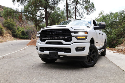 2025+ RAM 2500 light bar 40in PRO curved LED installed on white RAM 2500 truck front view on mountain road