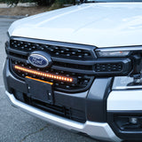 Close-up of the 30-inch SLIM LED light bar in the front grille of a white Ford Ranger